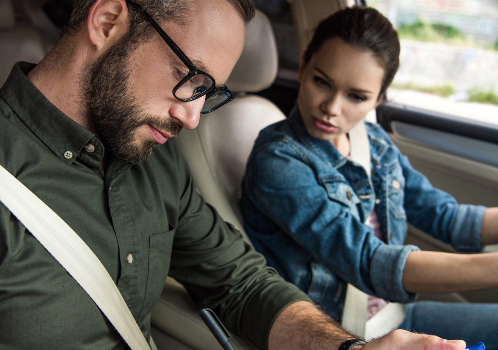 teacher-writing-something-to-clipboard-during-driving-test.jpg